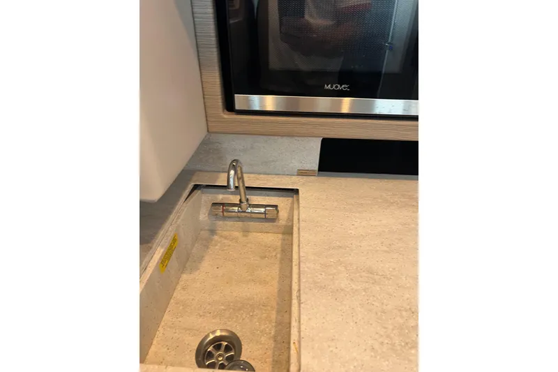 Slide: The Image of 2019 Formula 350 Crossover Bowrider I/O interior sink and microwave detail. - 11