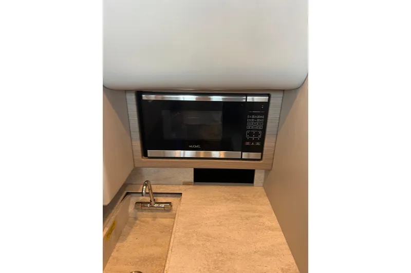 Slide: The Image of Microwave and sink in 2019 Formula 350 Crossover Bowrider I/O boat interior. - 12