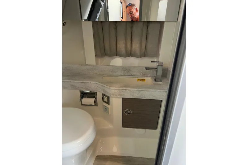 Slide: The Image of 2019 Formula 350 Crossover Bowrider I/O bathroom with modern sink and toilet. - 14