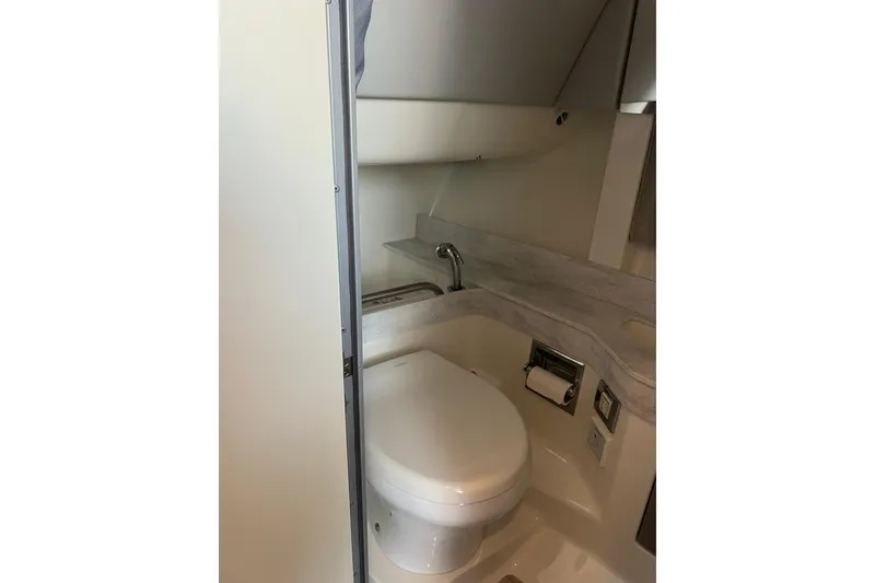 Slide: The Image of 2019 Formula 350 Crossover Bowrider I/O bathroom interior with toilet and sink. - 20