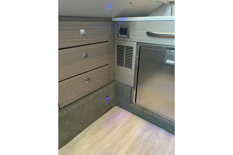 Slide: The Image of Interior of 2019 Formula 350 Crossover Bowrider I/O with wood cabinetry and stainless steel accents. - 23