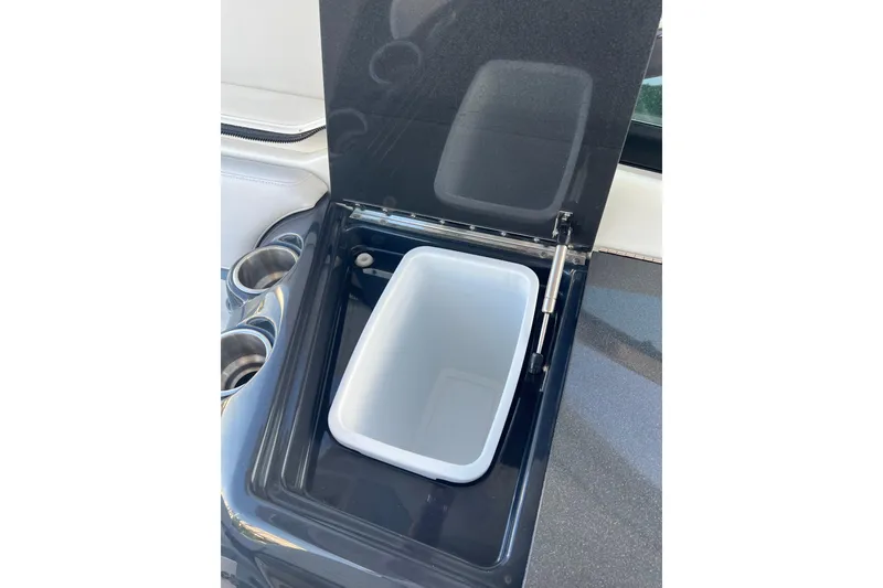 Slide: The Image of Open storage compartment with cup holders on a 2019 Formula 350 Crossover Bowrider I/O. - 27