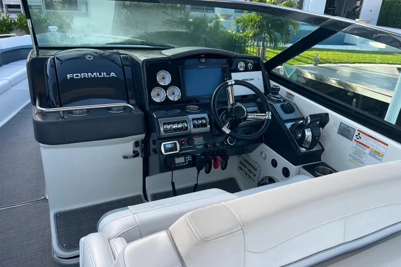 Slide: The Image of 2019 Formula 350 Crossover Bowrider I/O dashboard with steering wheel and controls. - 29
