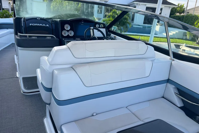 Slide: The Image of 2019 Formula 350 Crossover Bowrider I/O interior with white seating and modern dashboard. - 32