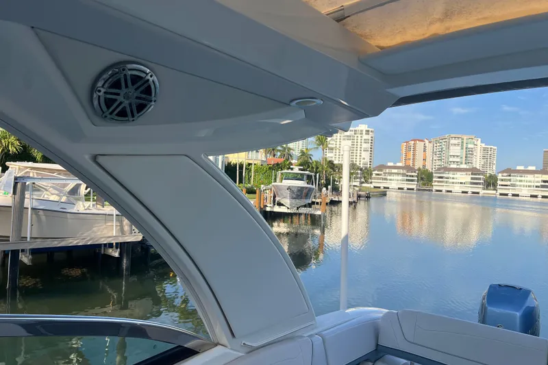 Slide: The Image of 2019 Formula 350 Crossover Bowrider I/O docked, with waterfront cityscape view. - 35