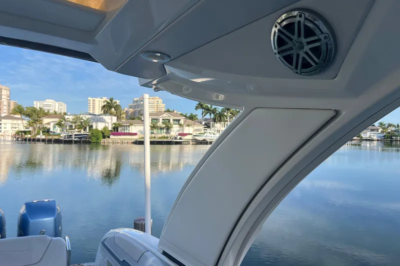 Slide: The Image of 2019 Formula 350 Crossover Bowrider I/O on serene waterfront with luxury homes. - 36