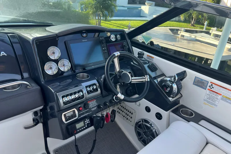 Slide: The Image of 2019 Formula 350 Crossover Bowrider I/O dashboard with steering wheel and navigation controls. - 37