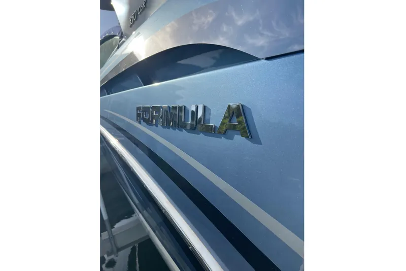 Slide: The Image of 2019 Formula 350 Crossover Bowrider I/O boat with sleek blue exterior design. - 4