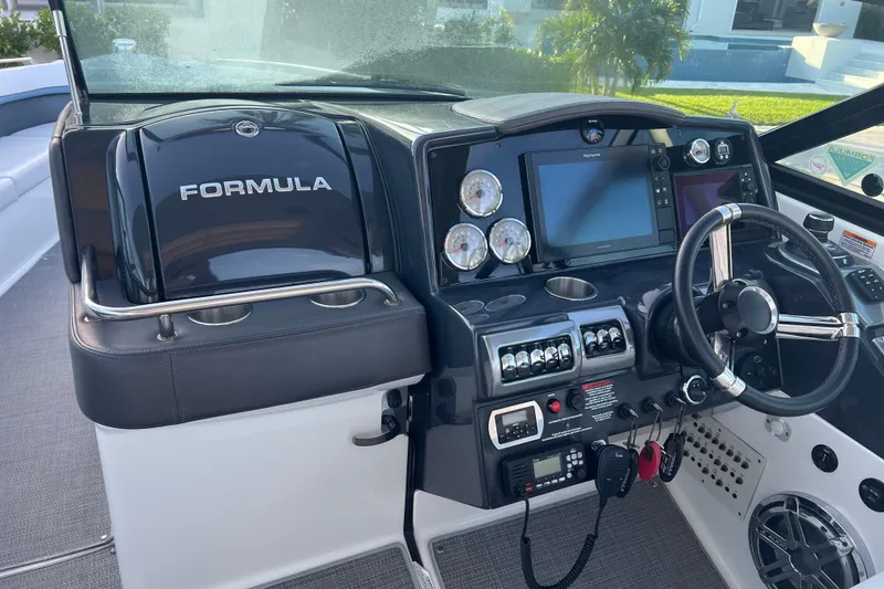 Slide: The Image of 2019 Formula 350 Crossover Bowrider I/O dashboard with steering wheel and navigation controls. - 44