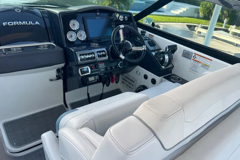 Slide: The Image of 2019 Formula 350 Crossover Bowrider I/O cockpit with modern controls and plush seating. - 46