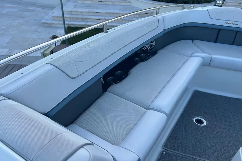 Slide: The Image of 2019 Formula 350 Crossover Bowrider I/O interior with cushioned seating and cup holders. - 51