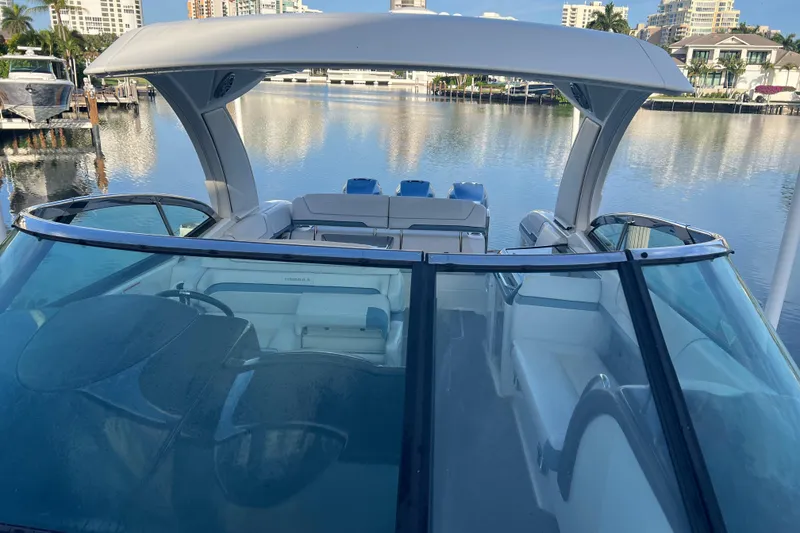 Slide: The Image of 2019 Formula 350 Crossover Bowrider I/O on calm water, showcasing sleek design and spacious seating. - 52