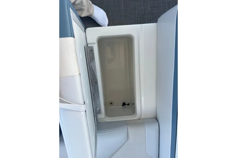 Slide: The Image of 2019 Formula 350 Crossover Bowrider I/O storage compartment, open view, with white and blue seating. - 53