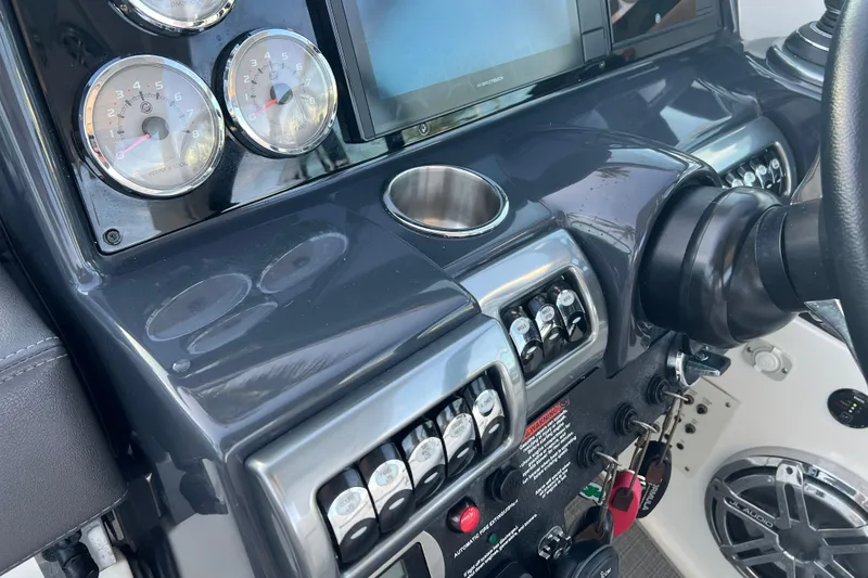 Slide: The Image of Dashboard of a 2019 Formula 350 Crossover Bowrider I/O with gauges and controls. - 55