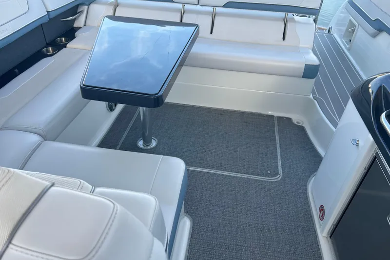 Slide: The Image of 2019 Formula 350 Crossover Bowrider I/O interior with seating and table. - 57