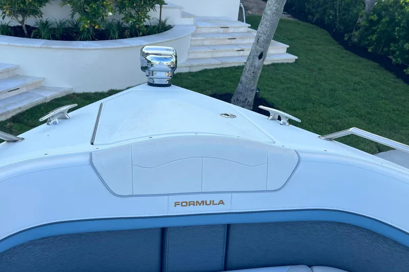 Slide: The Image of 2019 Formula 350 Crossover Bowrider I/O boat bow with chrome details and lush background. - 61