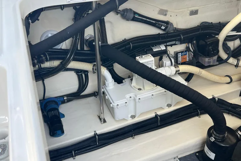 Slide: The Image of Engine compartment of a 2019 Formula 350 Crossover Bowrider I/O with visible hoses and components. - 65