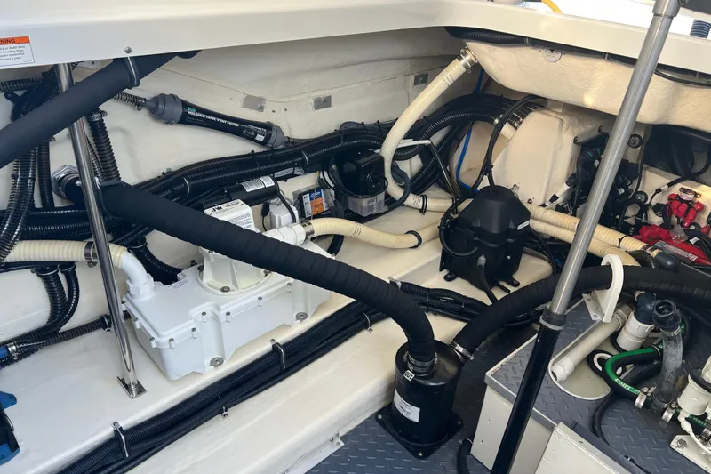 Slide: The Image of Engine compartment of a 2019 Formula 350 Crossover Bowrider I/O, showcasing intricate wiring and components. - 66