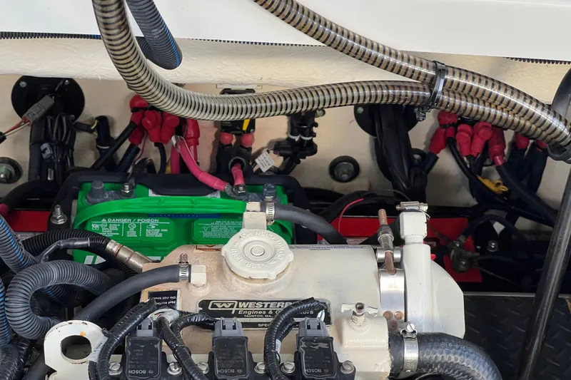Slide: The Image of Engine compartment of a 2019 Formula 350 Crossover Bowrider I/O with visible wiring and components. - 69