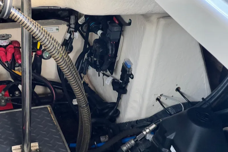 Slide: The Image of Engine compartment of a 2019 Formula 350 Crossover Bowrider I/O with visible wiring and components. - 71