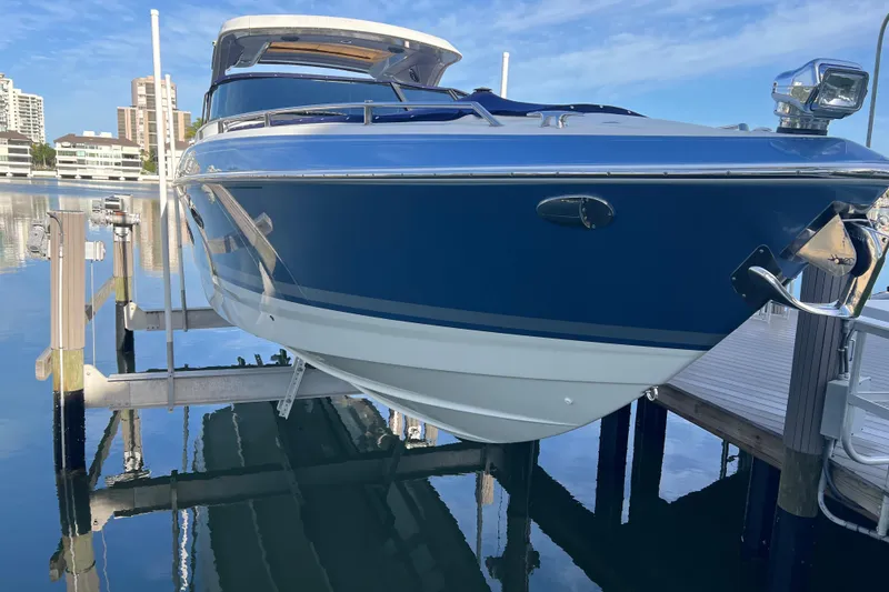 Slide: The Image of 2019 Formula 350 Crossover Bowrider I/O docked at marina, reflecting on calm water. - 73