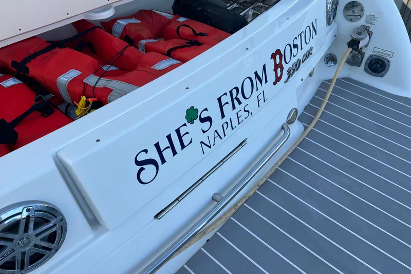 Slide: The Image of 2019 Formula 350 Crossover Bowrider I/O with life jackets, Naples, FL branding. - 78