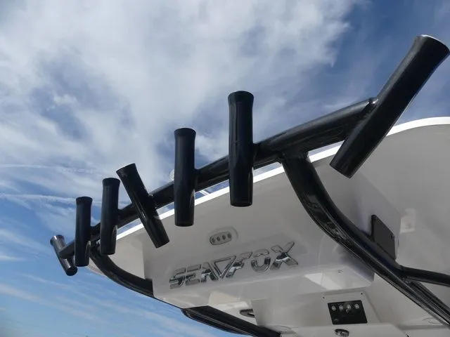 Slide: The Image of Sea Fox 268 Commander 2023 with rod holders against blue sky. - 22