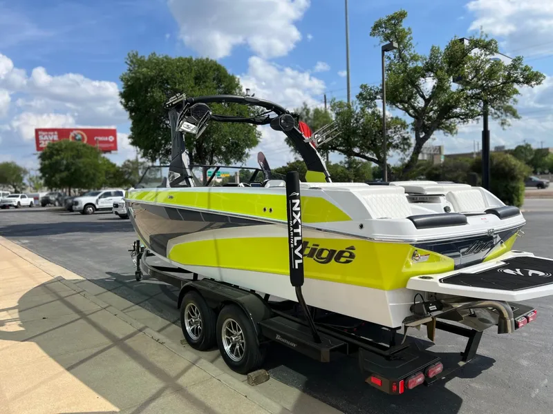 Slide: The Image of 2023 Tigé Z3 boat on trailer, bright yellow, parked outdoors. - 5
