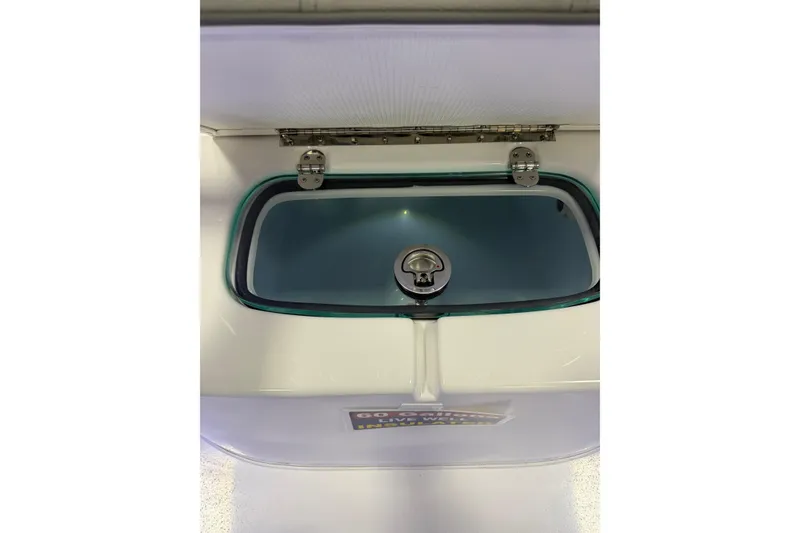Slide: The Image of Livewell compartment on a 2026 Cape Horn 28 XS boat, featuring a secure latch. - 10