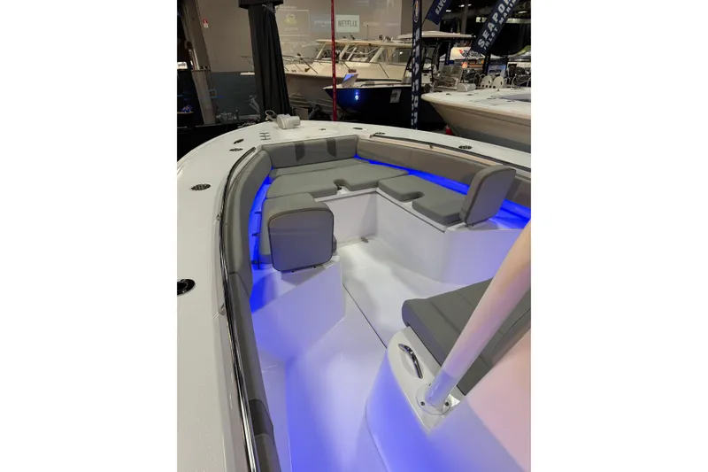 Slide: The Image of 2026 Cape Horn 28 XS boat interior with blue LED lighting and gray seating. - 12