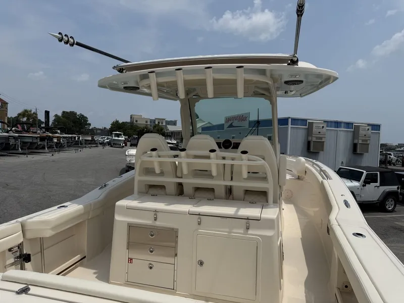 Slide: The Image of The image shows a Grady-White Canyon 326 boat with a spacious deck and multiple seats. - 13