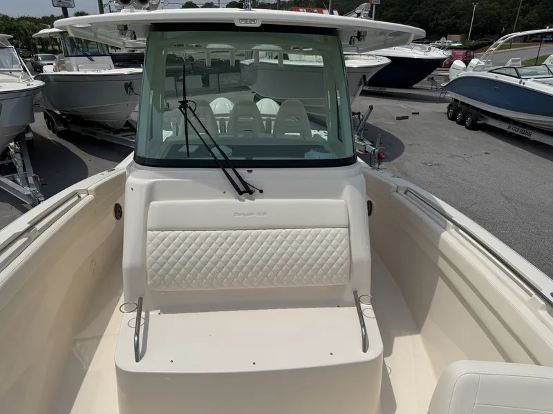 Slide: The Image of The image shows the cockpit of a 2026 Grady-White Canyon 326 boat with cushioned seating. - 31