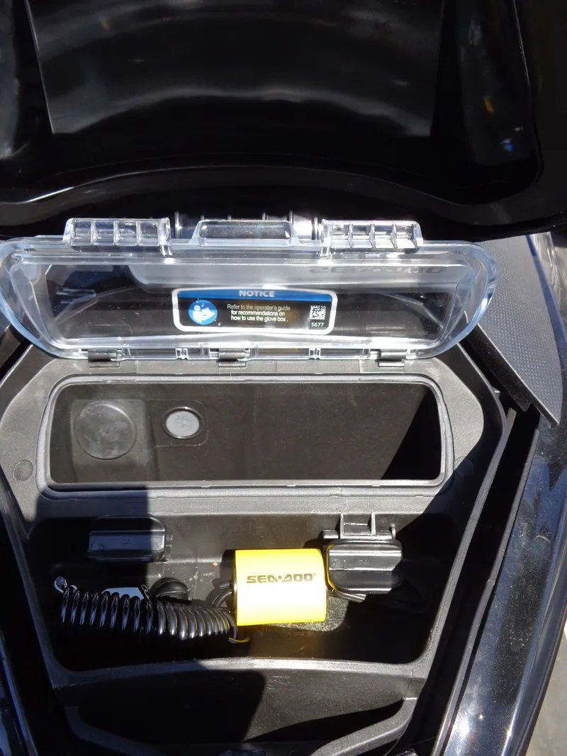 Slide: The Image of 2023 Sea-Doo GTX 170 IBR storage compartment with accessories. - 18