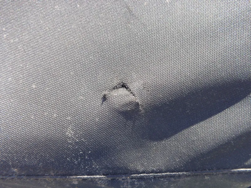 Slide: The Image of Close-up of a damaged seat cover on a 2023 Sea-Doo GTX 170 IBR. - 21