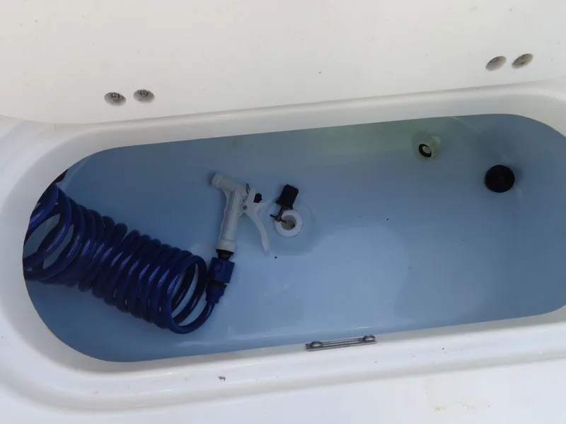 Slide: The Image of Interior view of Key West 189 FS boat with hose and spray nozzle. - 11