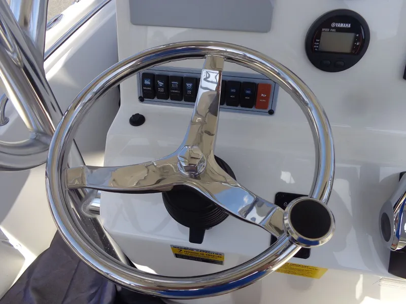 Slide: The Image of Steering wheel and dashboard of a 2023 Key West 189 FS boat. - 21