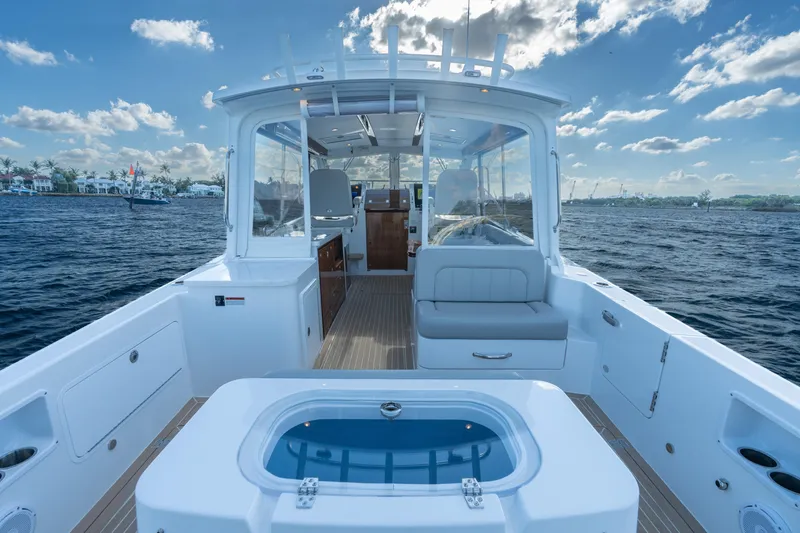 Slide: The Image of 2026 MJM 38RS boat interior with seating, ocean view, and clear sky. - 13