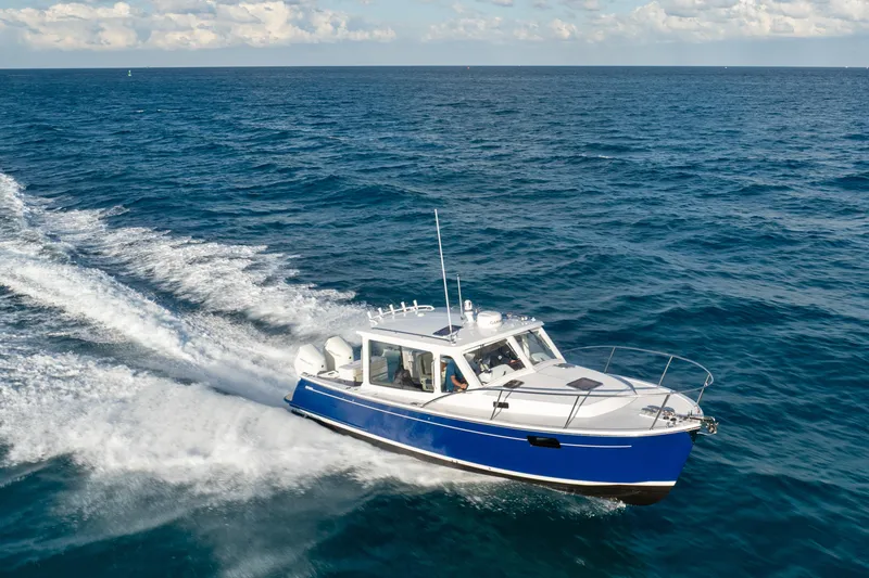 Slide: The Image of 2026 MJM 38RS boat cruising on open sea under clear skies. - 19