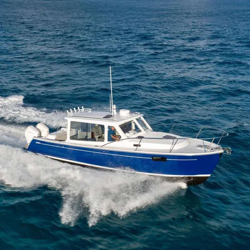 Slide: The Image of 2026 MJM 38RS boat cruising on open blue ocean waters. - 2