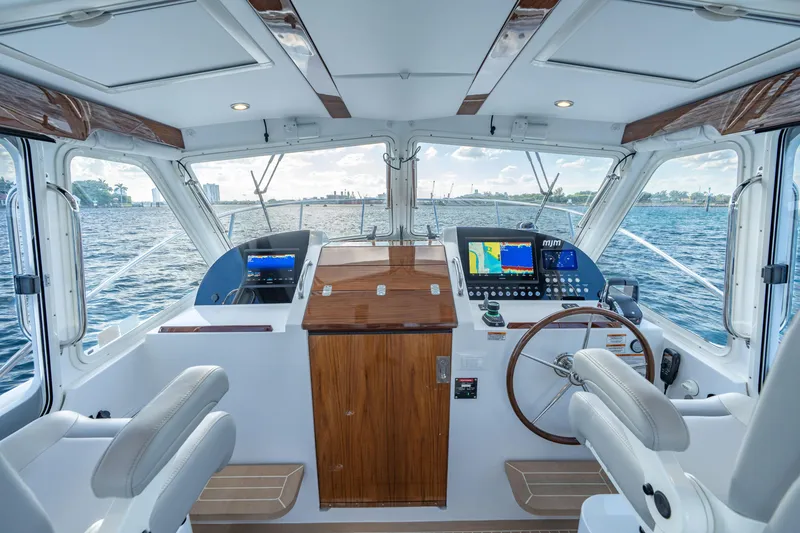 Slide: The Image of Interior view of 2026 MJM 38RS yacht cockpit with navigation displays and steering wheel. - 4