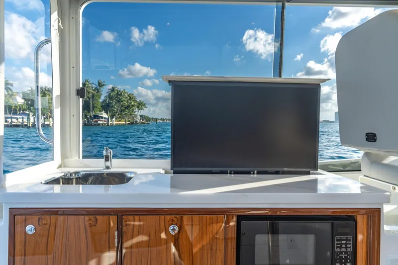 Slide: The Image of Interior of 2026 MJM 38RS yacht with sink, TV, and microwave, overlooking ocean. - 9