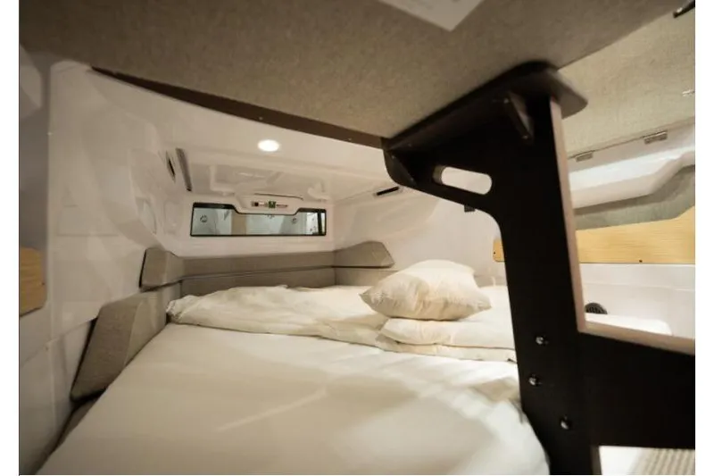Slide: The Image of Cozy cabin interior of 2027 Axopar 29 XC Cross Cabin with bed and pillows. - 6