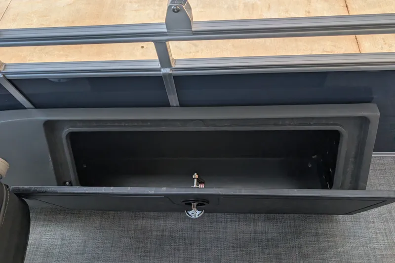 Slide: The Image of Storage compartment on 2026 Sun Tracker SportFish 22 DLX pontoon boat, open and empty. - 13