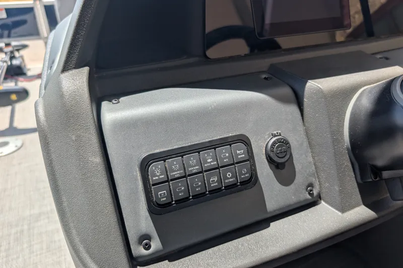 Slide: The Image of Dashboard controls of a 2026 Sun Tracker SportFish 22 DLX boat. - 14