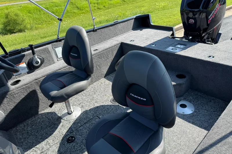 Slide: The Image of 2026 Tracker Pro Guide V-175 WT boat interior with gray seating and Mercury engine. - 2