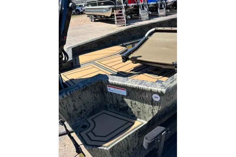 Slide: The Image of 2026 Tracker Grizzly 1650 T Prairie Wings Edition boat interior with camouflage design. - 10