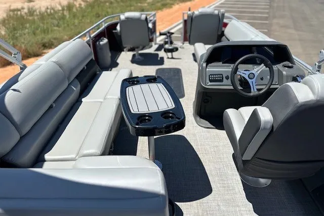 Slide: The Image of 2026 Sun Tracker Sportfish 24 XP3 pontoon boat interior with seating and steering console. - 22