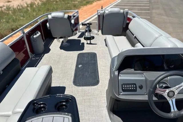 Slide: The Image of 2026 Sun Tracker Sportfish 24 XP3 pontoon boat interior with seating and steering console. - 14