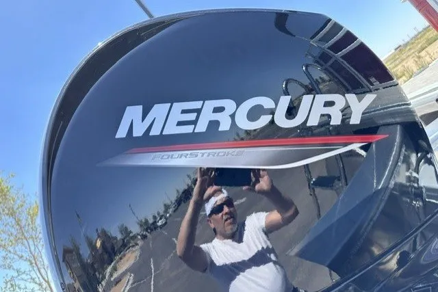 Slide: The Image of Mercury FourStroke engine on 2026 Sun Tracker Sportfish 24 XP3 boat, reflecting a person. - 116