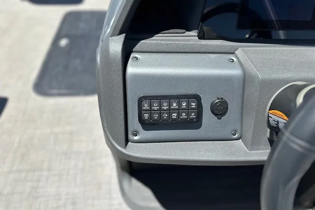 Slide: The Image of Control panel of 2026 Sun Tracker Sportfish 24 XP3 boat, featuring multiple switches. - 17